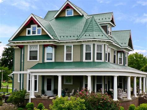 yellow house with green metal roof|exterior house colors brown roof.